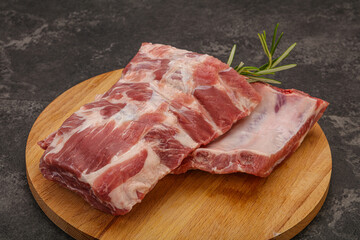 Raw pork ribs served rosemary