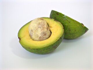 Closeup healthy and organic half avocado fruit with seed on white background , macro image