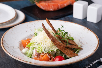 Tasty Caesar salad with salmon.