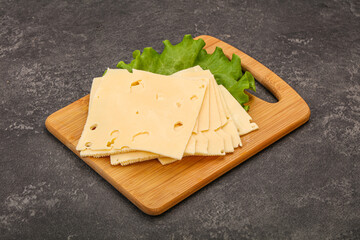 Sliced yellow cheese over board