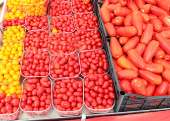 red tomatoes on sale at the local market in summer