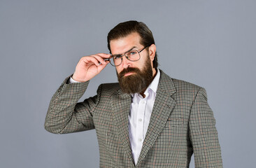 Confident and stylish. mens jacket wardrobe. fashionable man wear glasses. formal fashion model. handsome man on gray background. serious bearded businessman. stylish mature man looking modern