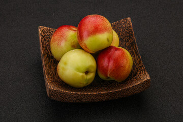 Sweet small nectarines in the basket