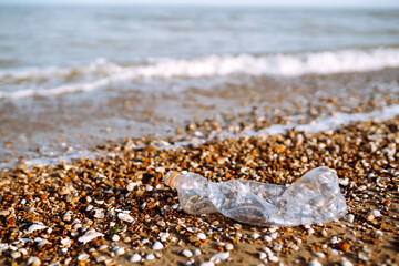 Empty plastic bottles on the beach,. Problem of global plastic pollution of the Earth.