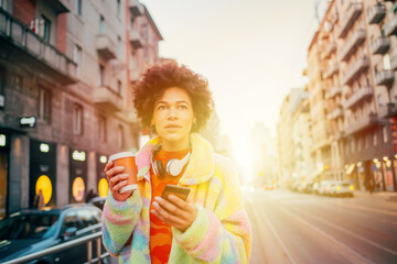 Fototapeta premium Young woman using smartphone on street