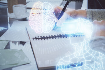 AR hologram over hands taking notes background. Concept of augmented reality. Double exposure