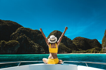 Traveler asian bikini woman relax and travel on boat in Maya Bay Phuket Thailand