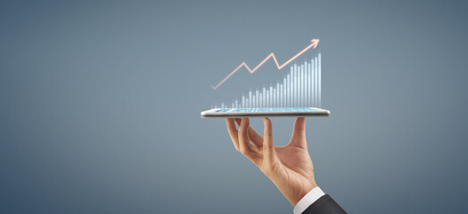 Business plan graph growth increase of chart positive indicators in his business, tablet in hand