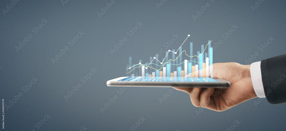 Wall mural business plan graph growth increase of chart positive indicators in his business, tablet in hand