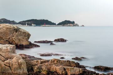 Fototapeta na wymiar Beautiful rock and waves on the seashore along the coastline.