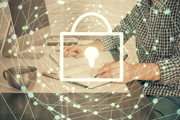 Double exposure of lock icon with man working on computer on background. Concept of network security.