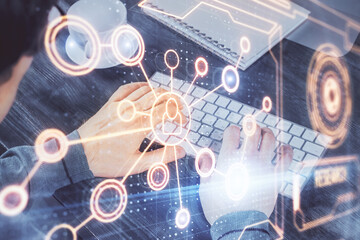 Social network theme hologram with businessman working on computer on background. Multi exposure.