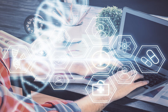 DNA hologram with businessman working on computer on background. Concept of bioengineering. Double exposure.