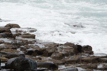 Waves crashing against rocks at the Giant's Causeway, Northern Ireland.