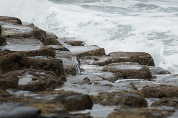 Waves crashing against rocks at the Giant's Causeway, Northern Ireland.