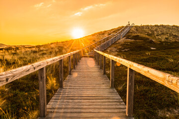 Fototapeta premium Sylt island wooden stairs at sunrise. Golden hour landscape