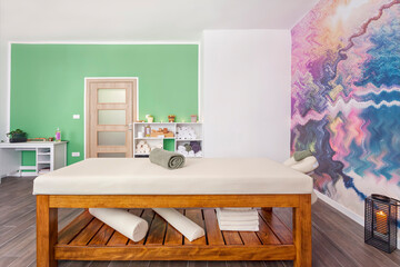 Interior of massage room with table bed in spa salon.