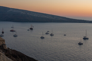 sunset with yachts on santorini island