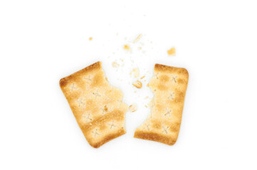 Cracker with pieces and crumbs on white background.