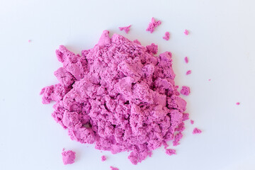 Kinetic sand of pink color on an isolated white background. Sand for children's creativity