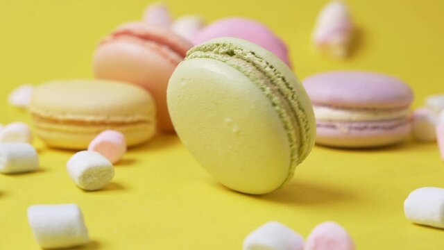 Delicious macarone to spin on yellow background bakery food color sugar pearl french dessert table macaroon slow motion
