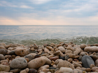 Fototapeta na wymiar beautiful seashore made of stones. Pebble beach. Turquoise water. Blue ocean. Summer