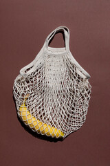 Fototapeta premium beige mesh zero waste bag pattern on a brown background