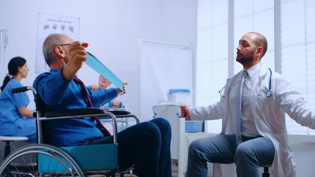 Recovery program for invalid senior persons, training with elastic band under doctor supervision in private recovery facility. Invalid physiotherapy program, health care injury rehabilitation in