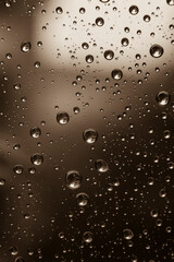 Drops of water on a window pane, raindrops on a window, abstract, black and white photo