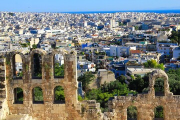 Greece, Athens, June 16 2020 - Partial view of the odeon of the Herodes Atticus with modern buildings in the background.