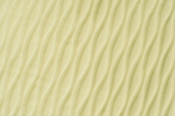 Soft blurred pale yellow rib waves fabric texture background.