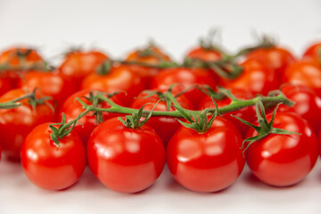 Cherry tomatoes close up on white background.