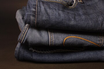 three pair of folded blue jeans