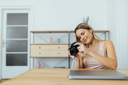 Portrait of a females journalist looking at pictures on camera.