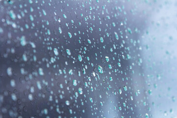 Naklejka na ściany i meble A small raindrop rests on the glass after rain.