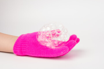 Child in brighte gloves holding soap bubble. happy childhood