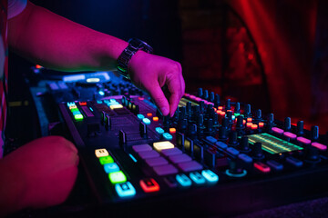 DJ plays music on professional music equipment controller mixer