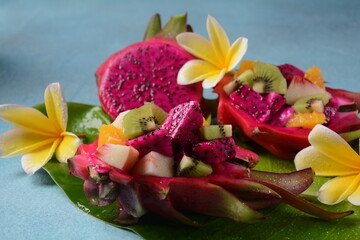 Dragon fruit (Pitaya, Pitahaya).Sliced pieces pitahaya fruit and fruit salad,and frangipani flowers.