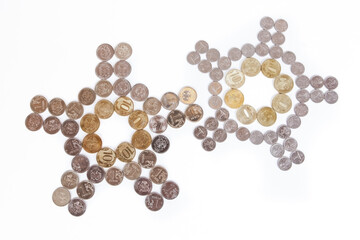 Coins laid out in the shape of a clock on a white background
