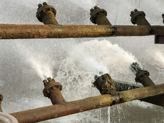 Treatment facilities. Water streams flow out of industrial pipes. Industrial water and their...