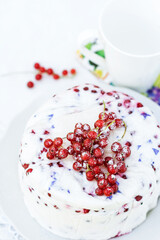 Homemade dessert of yogurt , berries and gelatin, decorated with raw red currants in white background with colorful napkin and cup, fresh, healthy food  concept