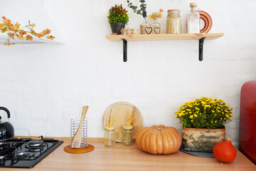 Autumn kitchen decoration with pumpkins, turquoise loft style kitchen decorated for Halloween or Thanksgiving