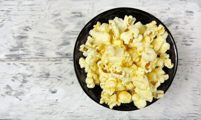    fresh popcorn in a black bowl  