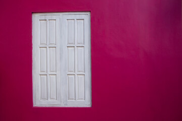 old wooden white window with pink painted wall