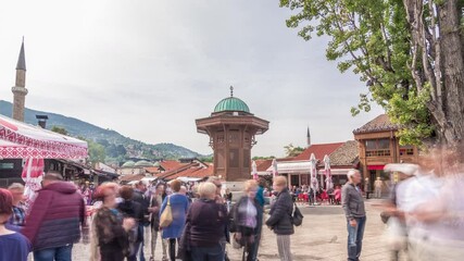 The Sebilj fountain in Sarajevo old city in Bosnia and Herzegovina timelapse hyperlapse. The Sebilj fountain is an Ottoman style wooden fountain in the centre square in Sarajevo