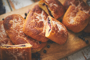 Tasty blueberry bun stuffed with fresh forrest fruits. Traditional polish bun called jagodzianka