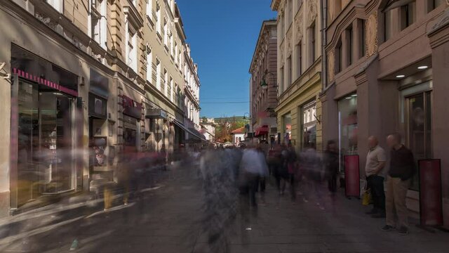 Walk on Ferhadija pedestrian street crowded with people timelapse hyperlapse. Famous place in downtown with many shops and reastaurants in Sarajevo