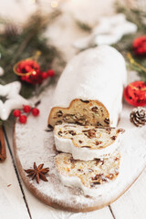 Obraz na płótnie Canvas Christmas stollen on wooden background. Traditional Christmas festive pastry dessert. Stollen for Christmas.