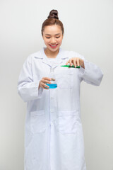 Scientist in uniform holding beaker and test tube have chemical liquid for testing chemical reaction.