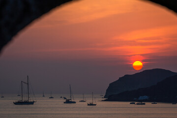 Fototapeta na wymiar sunset with yahts on Santorini island Greece